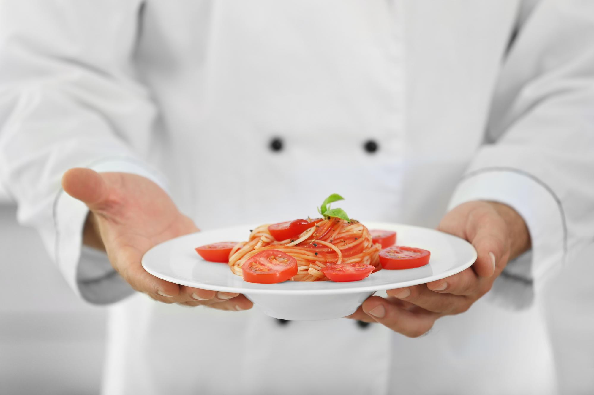 Chef preparing plated dish in artisan kitchen